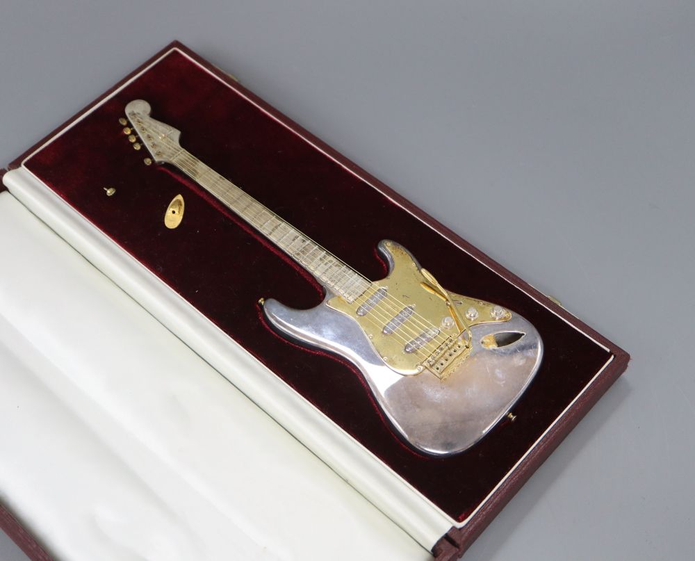 A late 1960s cased parcel gilt silver miniature model of a Fender Stratocaster, maker, TL, Birmingham, 1969, 24.4cm.